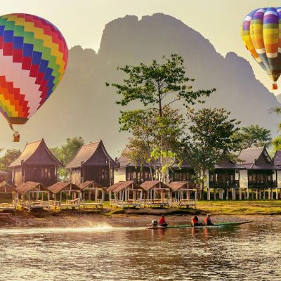 Hot air balloon over Nam Song river at sunset in Vang vieng, Laos.